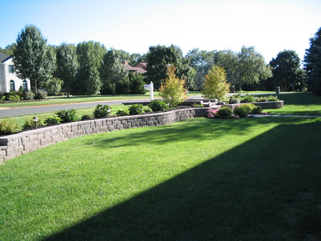 Stone retaining wall with lawn